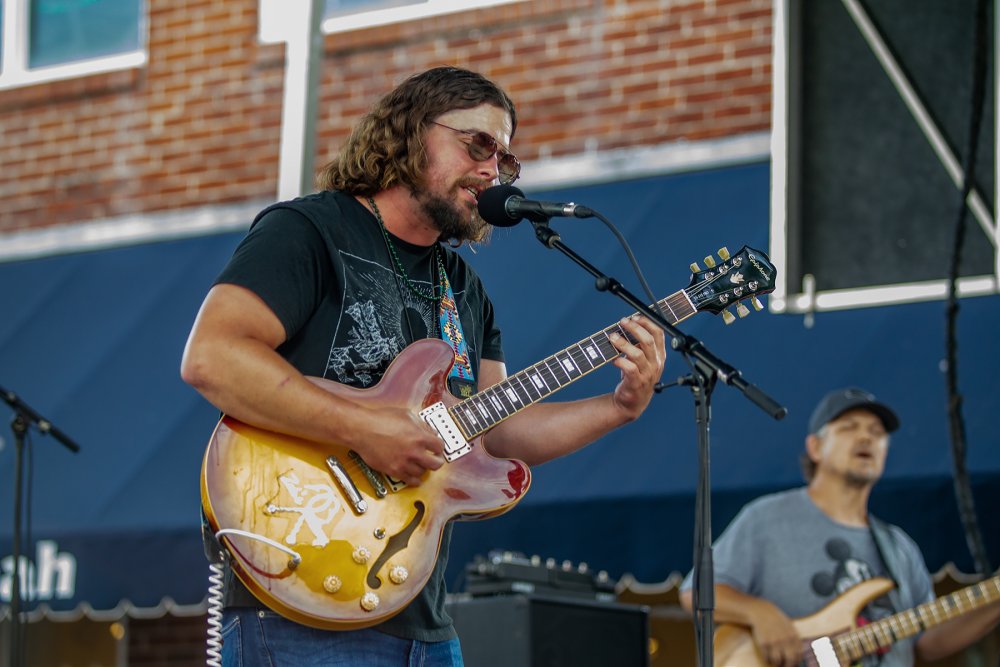 Savannah City Market guitarist on stage at Art & Soul Festival 2024