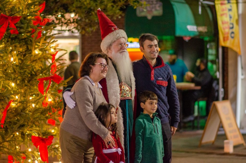 Santa posing with a family at City Market