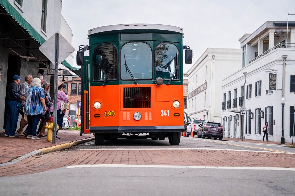 People in line waiting to board a trolley at Savannah City Market